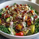 Massaged kale meets roasted red bell peppers, zucchini, and crunchy almonds and seeds.