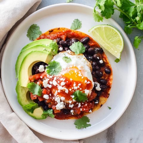 Vibrant Huevos Rancheros, a hearty Mexican breakfast with runny eggs and spicy sauce.