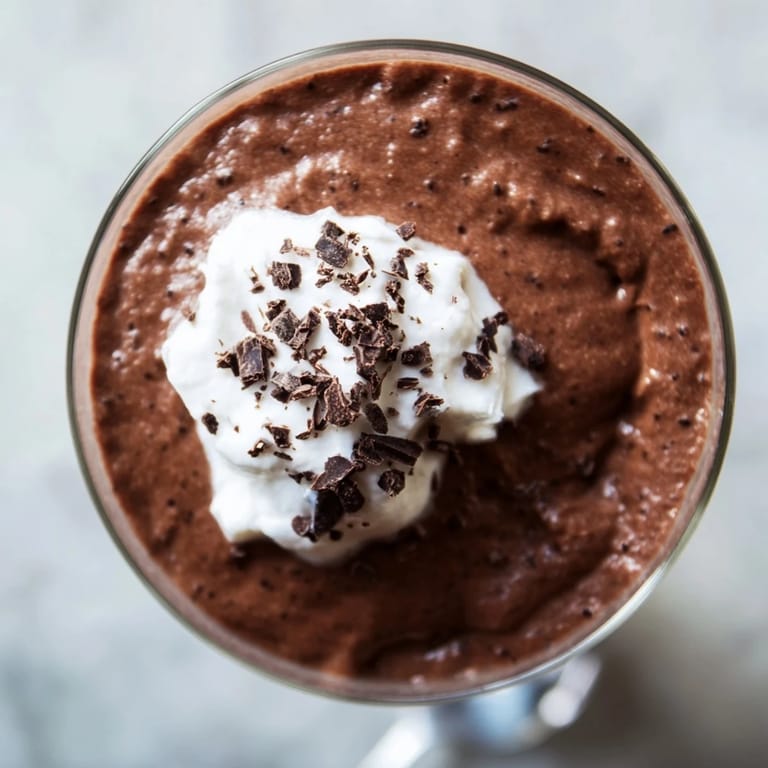 Individually plated chocolate pudding dessert garnished with fresh berries for a sweet finish.