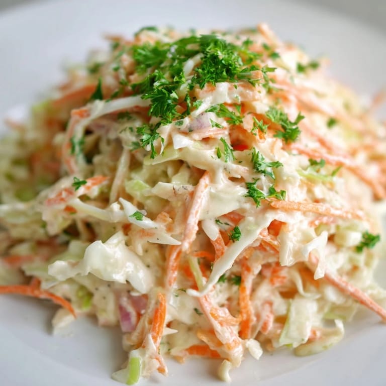 A refreshing Coleslaw with Apple highlights grated sweet-tart apples, creamy dressing, and a bright sprinkle of fresh parsley.